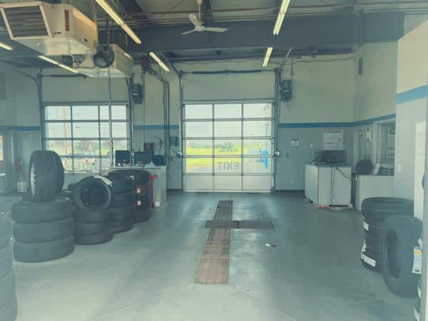 Auto service garage with stacked tires and workstations, ready for maintenance tasks.